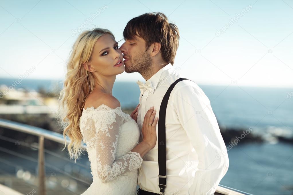 Handsome young groom kissing his wife