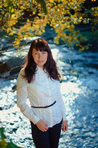 beautiful girl 30 years in business suit walking in the autumn forest