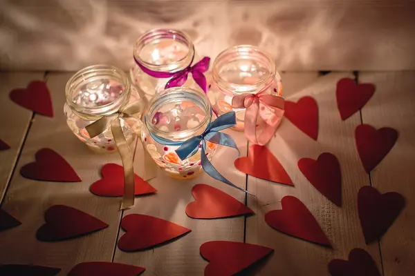 Glass jars with candles for Valentine's Day — Stock Photo, Image