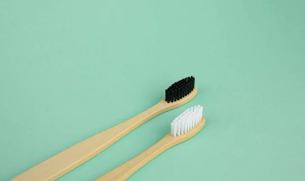 Natural Bamboo Toothbrushes White Black Bristles Mint Green Background Concept — Stock Photo, Image