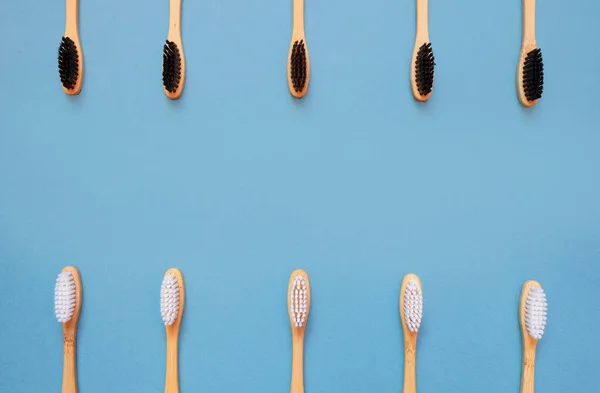 Bamboo toothbrushes on blue. Zero waste, eco-friendly dental care for your mouth. Safe environmentally friendly toothbrush concept. Flat lay, top view, copy space.