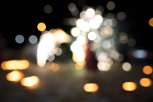 Abstract background of blurry bokeh lights, different colors, orange, red, yellow, bright color fireworks or fire salute
