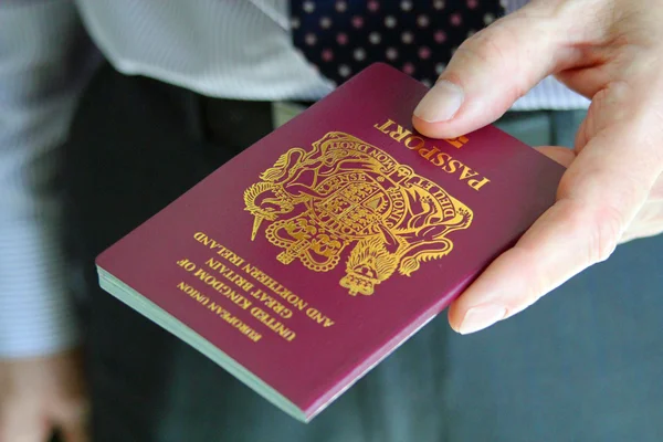 Handing over a UK passport — Stock Photo, Image