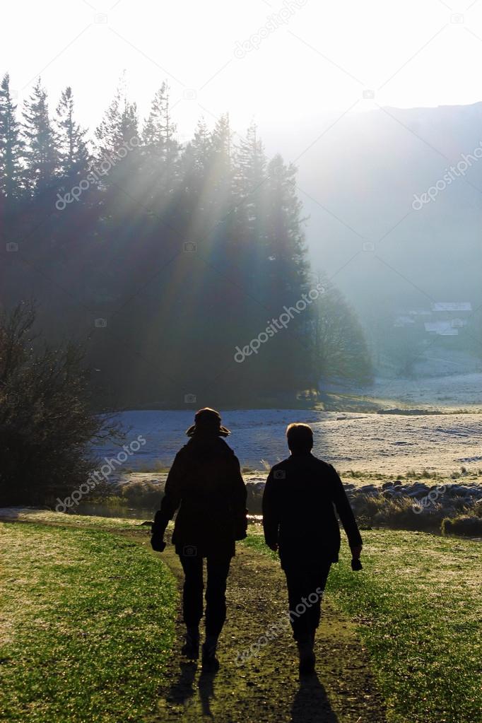 Silhouette of two walkers