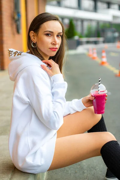 Miss in white sweatshirt and pink drink