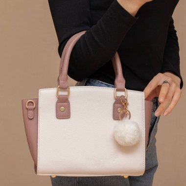 Bir kız bir çanta kadar işlevseldir. Kız beyaz çantayı sunar.