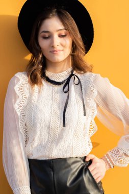 Sarı arka planda şapkalı kız. Sarı arka planda bir kız