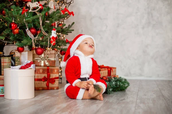 Cute Baby Santa Sits Home Christmas Tree Gifts — Stock Photo, Image