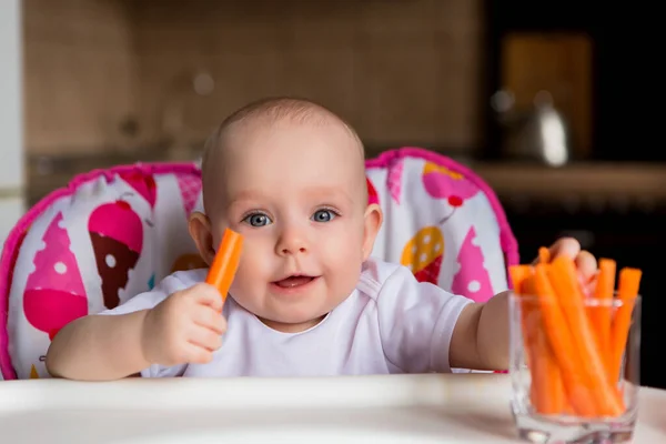 cute little baby having food in colorful baby chair