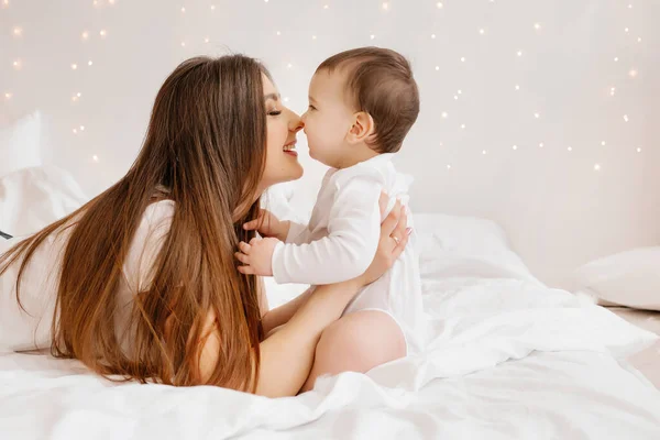 Happy Young Mom Hugs Toddler Bed — Stock Photo, Image