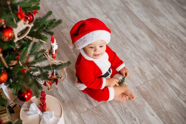 Cute Baby Santa Sits Home Christmas Tree Gifts — Stock Photo, Image