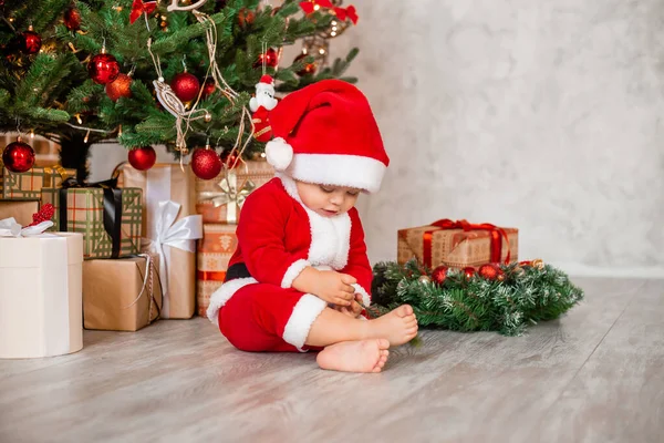 Cute Baby Santa Sits Home Christmas Tree Gifts — Stock Photo, Image