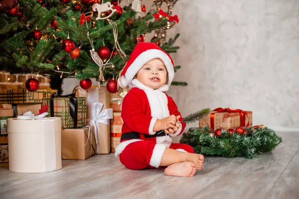 Cute Baby Santa Sits Home Christmas Tree Gifts — Stock Photo, Image