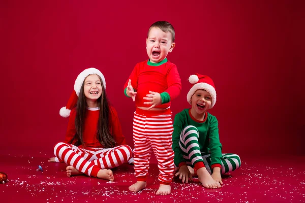 Boy Girl Sitting Floor Laughing Crying Brother Red Studio Background — Stockfoto