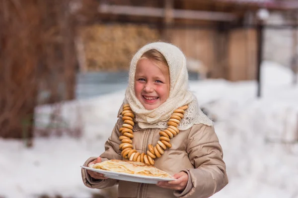Girl with pancakes in the Russian shawl — Stock Photo, Image