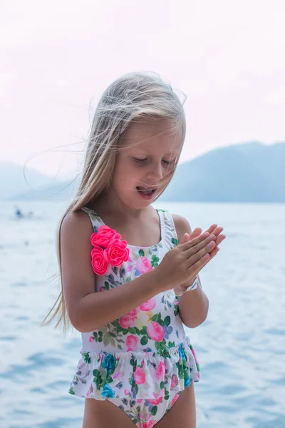 portrait of a beautiful girl with long hair on the beach