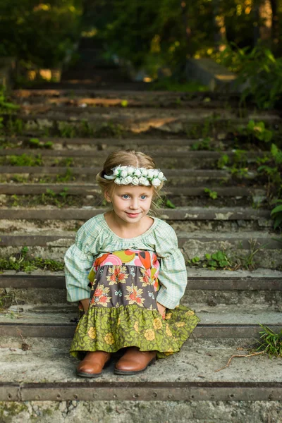 Russe fille en robe nationale assis sur les escaliers jour d'été — Photo