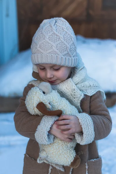 Little girl with a toy lamb — Stock Photo, Image