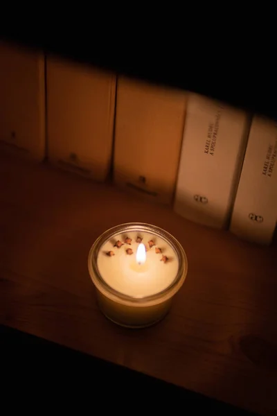 Soy candle lights old book in the library — Stock Photo, Image