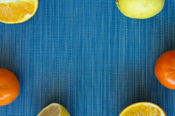 citrus food flat lay border pattern on blue background - assorted citrus fruits