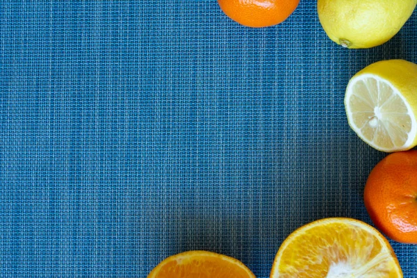 citrus food flat lay border pattern on blue background - assorted citrus fruits