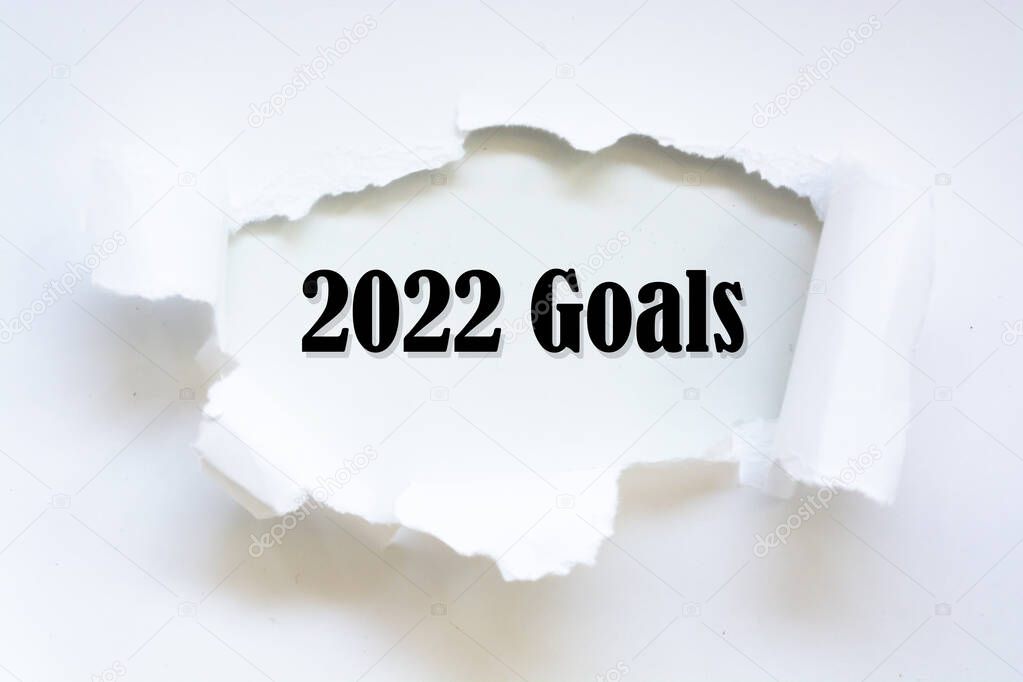 2022 Goals word written under torn paper concept.