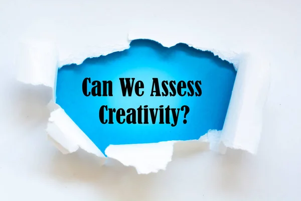 Can We Assess Creativity? question written under torn paper.