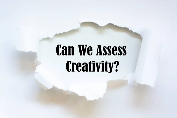 Can We Assess Creativity? question written under torn paper.