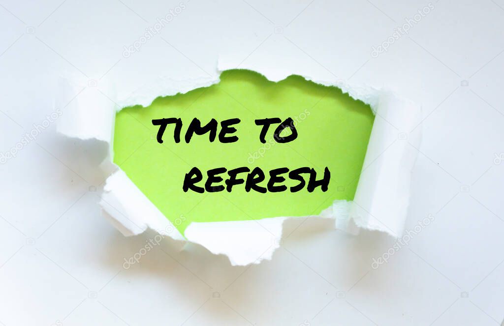 The word time to refresh appearing behind torn paper