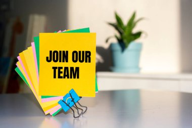 Mantar tahtası arkaplanı üzerinden renkli etiket notları üzerine yazılmış takımımıza katıl.