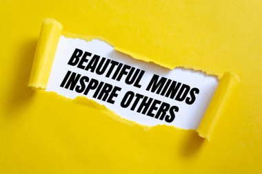 Beautiful Minds Inspire Others message written under torn paper.