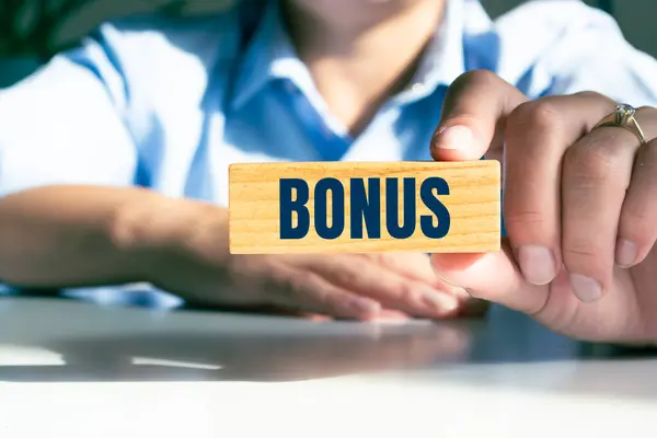 Bonus metin ile tahta blok tutan adam.
