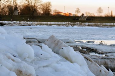 Piled ice chunks and ice floes blocking the Lielupe River near Jelgava, Latvia, during the dangerous winter or spring ice jam.