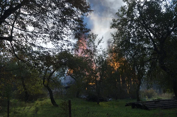 Oheň hoří dřevěným domem — Stock fotografie