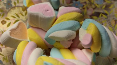 Dekoratif bir tabakta rengarenk şekerlemeler ve kalp şeklinde şekerler. Yumuşak pastel tatlılar Sevgililer Günü, çocuk partileri ya da tatlı menüleri için mükemmel..