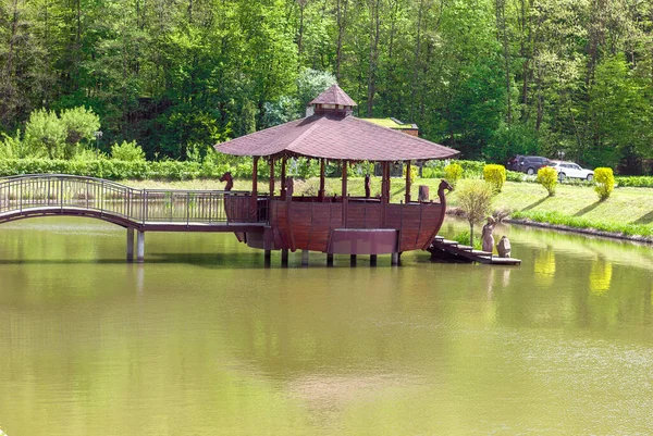 Wooden building gazebo restaurant on the water in the form of an old ship, outdoor recreation in the park