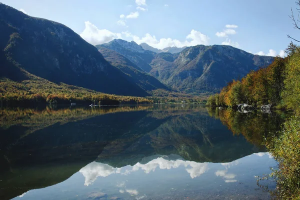Scenic view of beautiful mountains landscape and Bohinj lake with blue sky