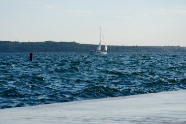 Picturesque seaside resort town in Slovenian coast against orange blue sky in summer. Scenic view to Adriatic sea in the evening. Travel, transportation concept. 