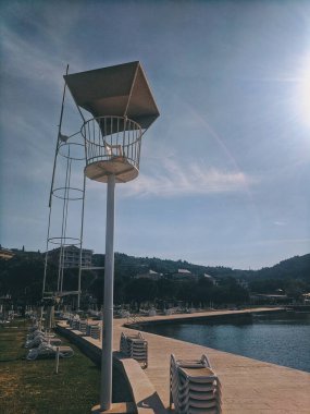 Scenic view to the amazing red sunset at the Adriatic sea, coast in Slovenia at summer. View to green hills with palms and olive trees. Natural backgrounds. 