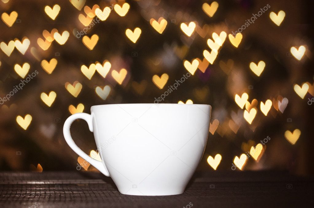 Cup of coffee with heart bokeh background