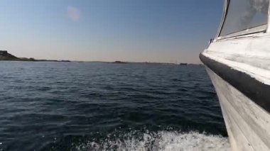 Yat güvertesindeki manzarayı deneyin, canlı yeşil deniz ve dalgalı dalgaların yakın plan bakış açısını gösterin. Bu yaşam tarzı, özgürlük ve macerayı temsil eder..