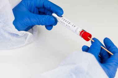 Coronavirus COVID-19 testing kit,swab collection equipment,sterile vacutainer with swabbing stick,closeup of hands in blue protective gloves holding the test tube,rt-PCR sample specimen testing clipart