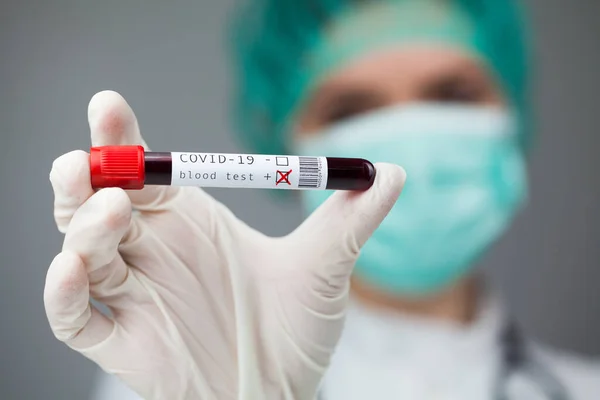 Doctor in green holding test tube with Coronavirus patient blood sample, POSITIVE Covid-19 deadly corona virus disease test results, global pandemic crisis, hematology testing procedure illustration