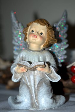 Angel 'ın elinde İncil' den bir Noel süsü var. 21.12.2020