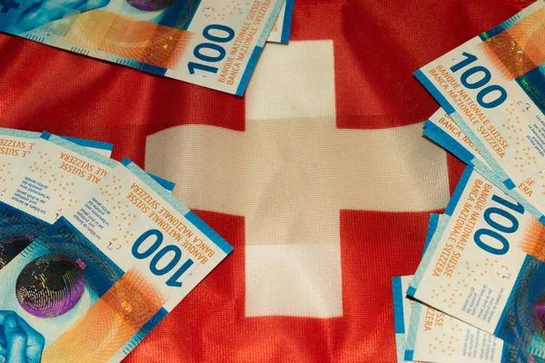 Swiss flag with bank notes in the value of one hundred each 27.5.2021