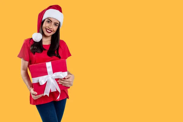Woman Christmas Hat Holding Gift Isolated Yellow Background Stock Photo