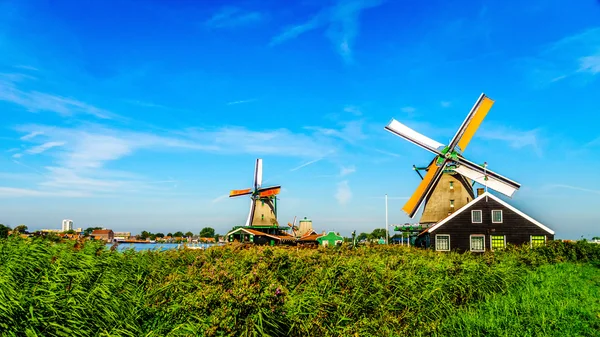 Fully operational historic Dutch Windmills along the Zaan River at the village of Zaanse Schans in the Netherlands — Stock Photo, Image