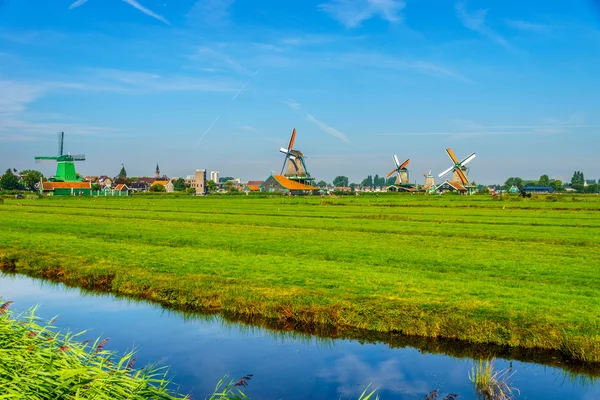 Fully operational historic Dutch Windmills along the Zaan River at the village of Zaanse Schans in the Netherlands — Stock Photo, Image