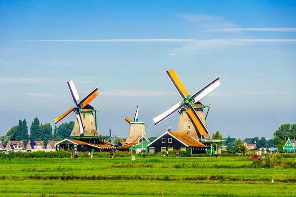 Fully operational historic Dutch Windmills along the Zaan River at the village of Zaanse Schans in the Netherlands — Stock Photo, Image