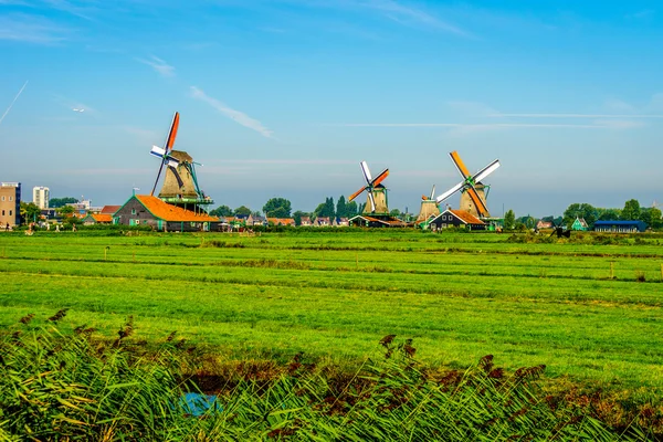 Fully operational historic Dutch Windmills along the Zaan River at the village of Zaanse Schans in the Netherlands — Stock Photo, Image